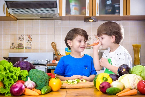 Healthy eating. Happy children prepares and eats vegetable salad