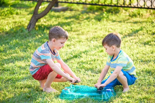 Two Boys Playing Modern Spin Top Outdoors Entertainment Game Children Stock Image