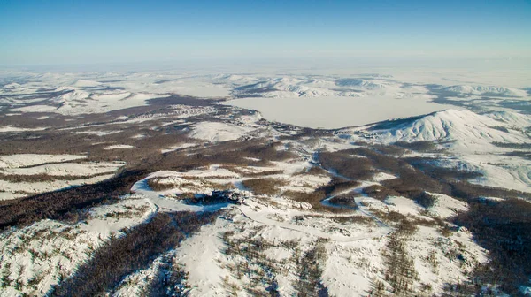 Russian Ural mountains in winter. Aerial view lake, white infinity