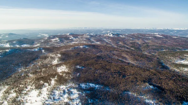 Russian Ural mountains in winter. Aerial view lake, white infinity