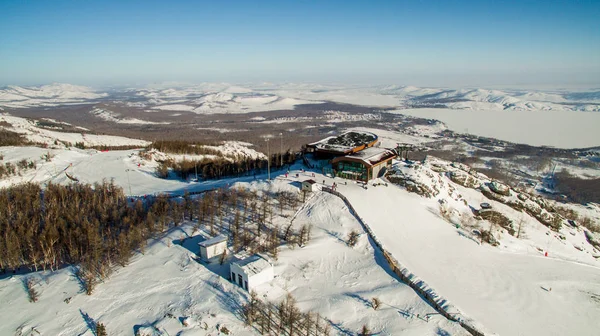 Les skieurs et les snowboarders descendent le flanc de la montagne près du lac Bannoe. Aérien Images De Stock Libres De Droits