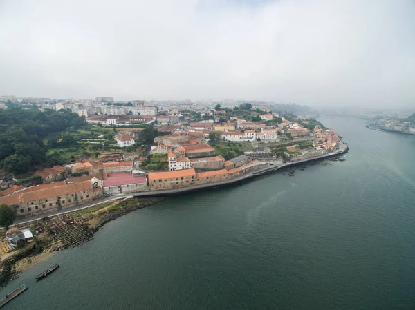 Panoramic view of the old city of Porto. One flew over the roofs of the houses, a river and a bridge. — Stock Photo, Image