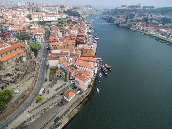Panoramic view of the old city of Porto. One flew over the roofs of the houses, a river and a bridge. — Stock Photo, Image