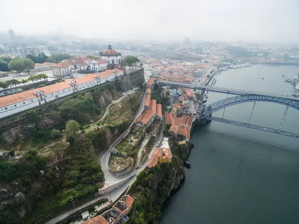 Panoramic view of the old city of Porto. One flew over the roofs of the houses, a river and a bridge. — Stock Photo, Image