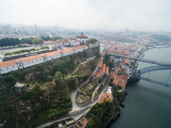 Panoramic view of the old city of Porto. One flew over the roofs of the houses, a river and a bridge. — Stock Photo, Image