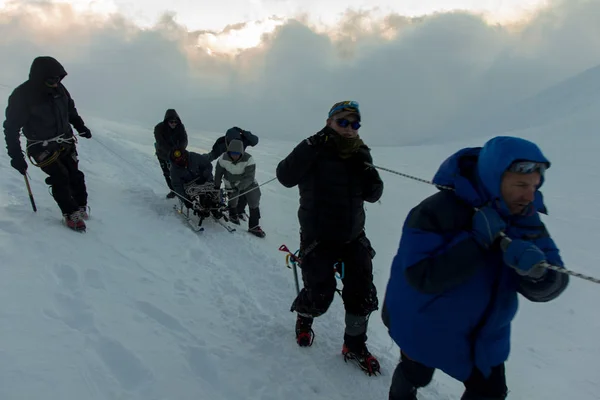 2014 elbrus, russland: mit einem behinderten mann nach oben klettern. — Stockfoto