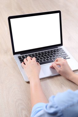 Business woman using mock up laptop on wooden desk