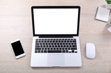 Top view mock up screen laptop and smartphone on wooden desk
