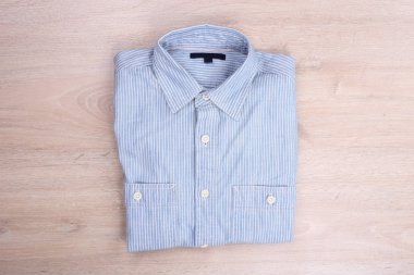 Top view casual shirt on wooden background