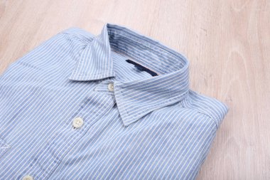 Casual shirt on wooden background