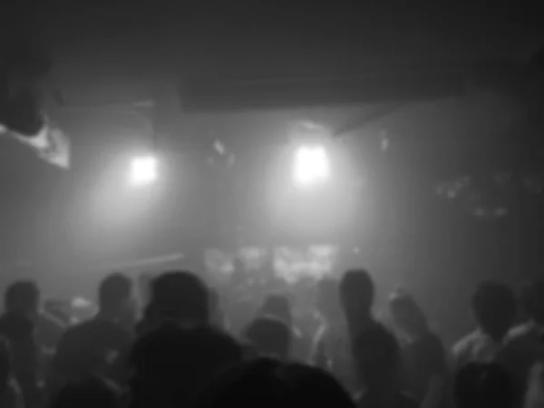 Crowd peoples dancing with DJ music in nightclub