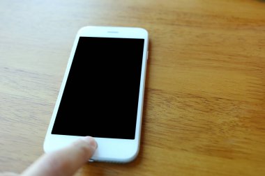 Hand press on home button of smartphone