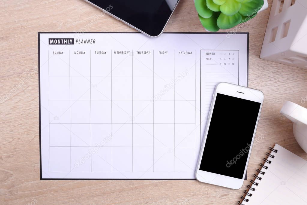  blank screen smartphone planner schedule and office supplies on