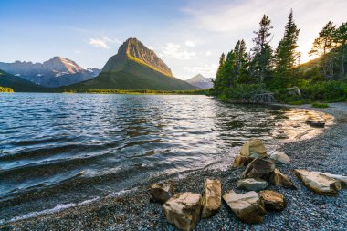 Swiftcurrent Gölü 'nde güzel bir manzara. Çok Buzul Bölgesi' nde güneş doğduğunda Montana 'daki Buzul Ulusal Parkı, Montana, ABD.