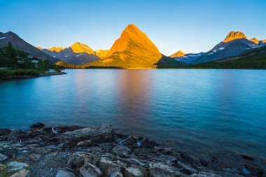Swiftcurrent Gölü 'nde güzel bir manzara. Çok Buzul Bölgesi' nde güneş doğduğunda Montana 'daki Buzul Ulusal Parkı, Montana, ABD.