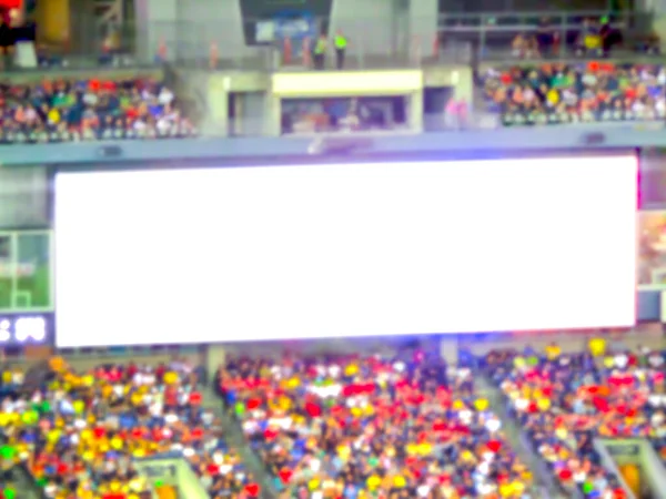 scene of big white led billboard with a lot of fans in the big stadium. -blurred picture..