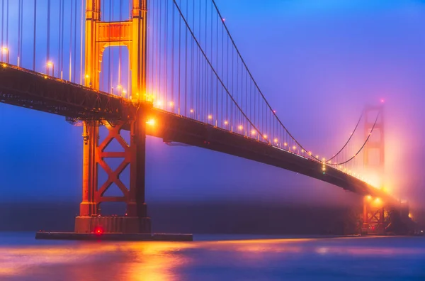 scenic view of Golden gate in the in the dusk with lighting and reflection on the water and fog,San Francisco,California,usa.