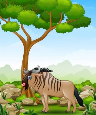 Cartoon wildebeest mascot in the jungle clipart