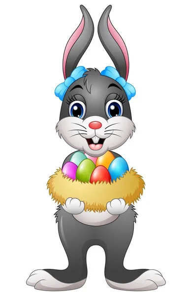 Easter bunny holding easter eggs in nest — Stock Vector