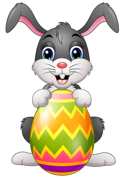 Coelho dos desenhos animados segurando ovo de Páscoa — Vetor de Stock