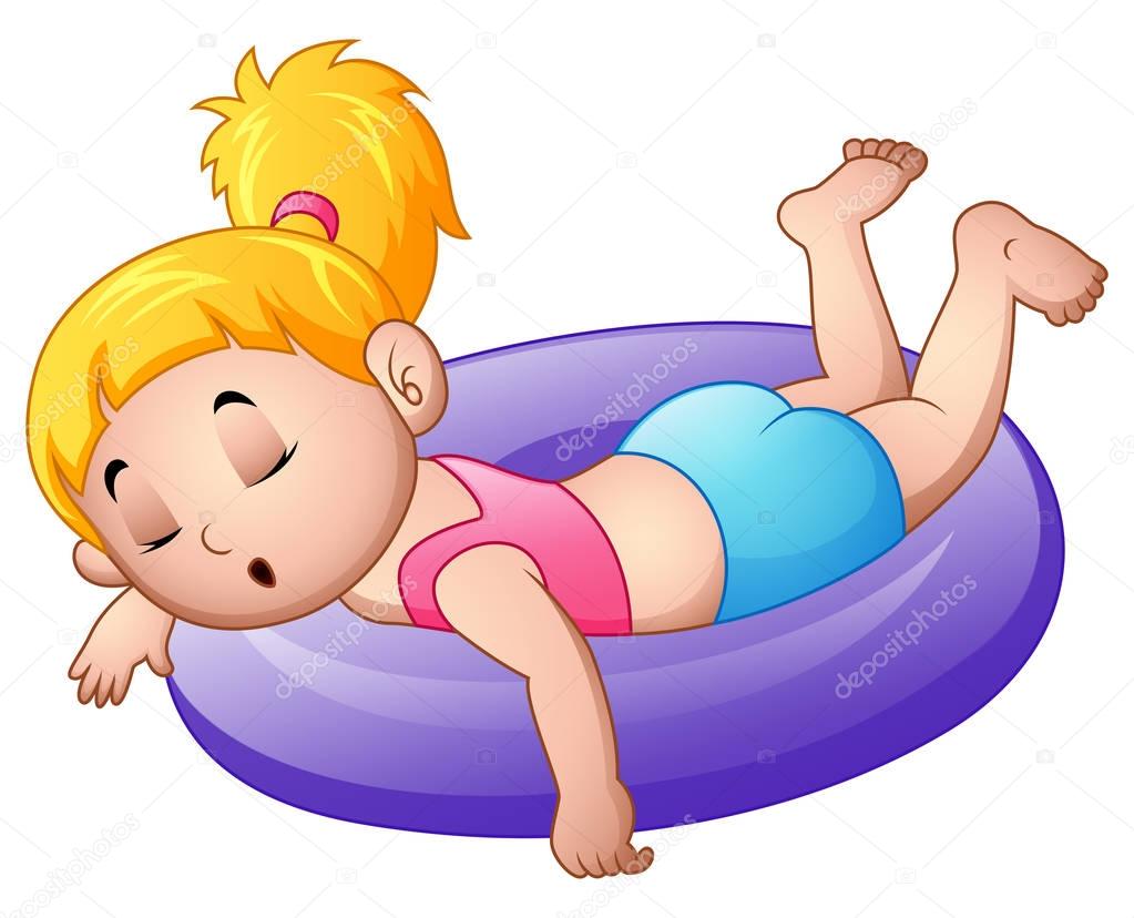 Little girl sleeping above an inflatable ring