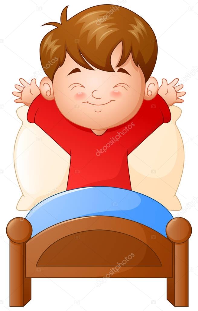 Little boy waking up in a bed on white background