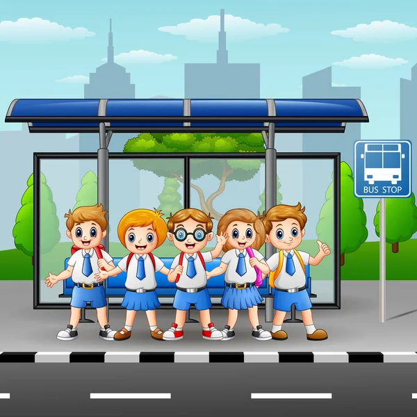 Niños de la escuela feliz en la parada de autobús — Vector de stock