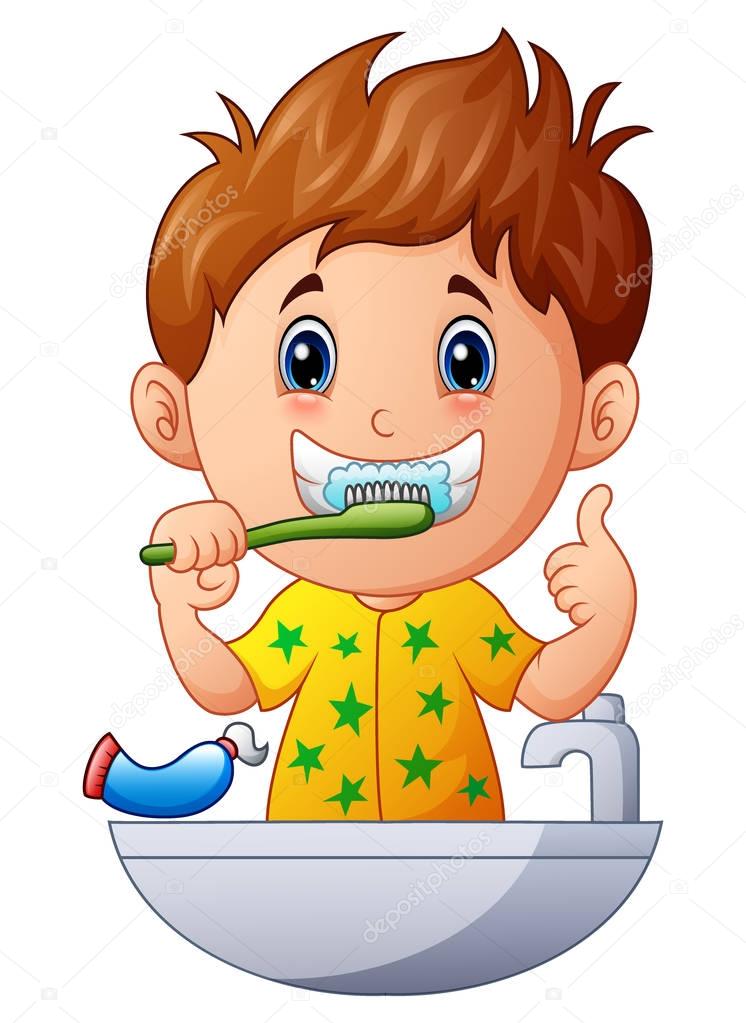 Cute boy brushing teeth