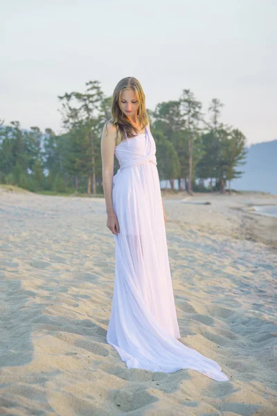 stock image Beautiful girl walking on the beach.