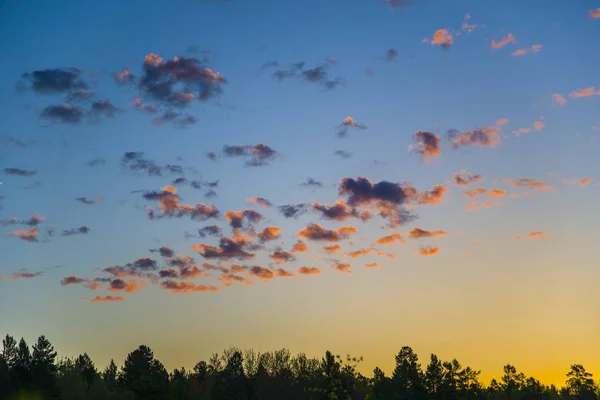 The sky is painted in bright red shades.