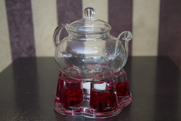 The stand and candle for heating water in the kettle.