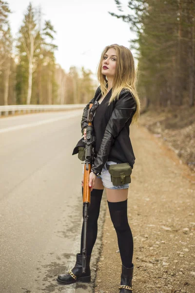 Une fille assassin attend sa victime sur la route . — Photo