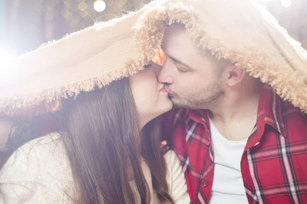 Liefhebbers van de jonge man en de vrouw verborgen onder een zachte deken. — Stockfoto