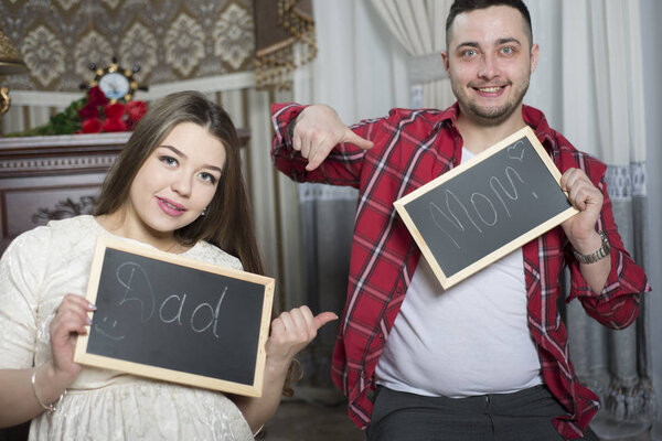 Happy young parents expecting the birth of their unborn child.