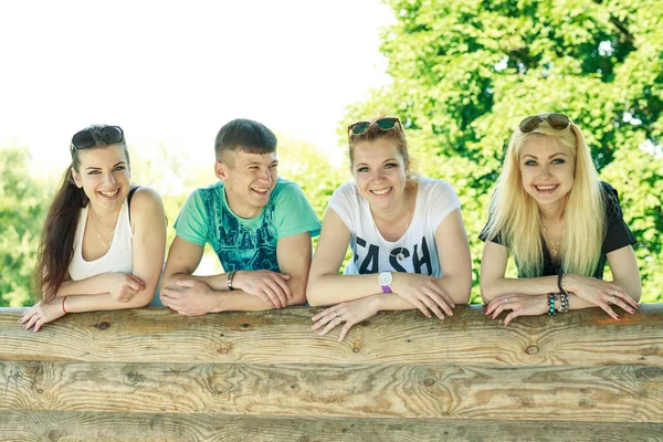 People, freedom, happiness, and teenage concept - group of happy friends go out and fun on a background of green trees — Stock Photo, Image