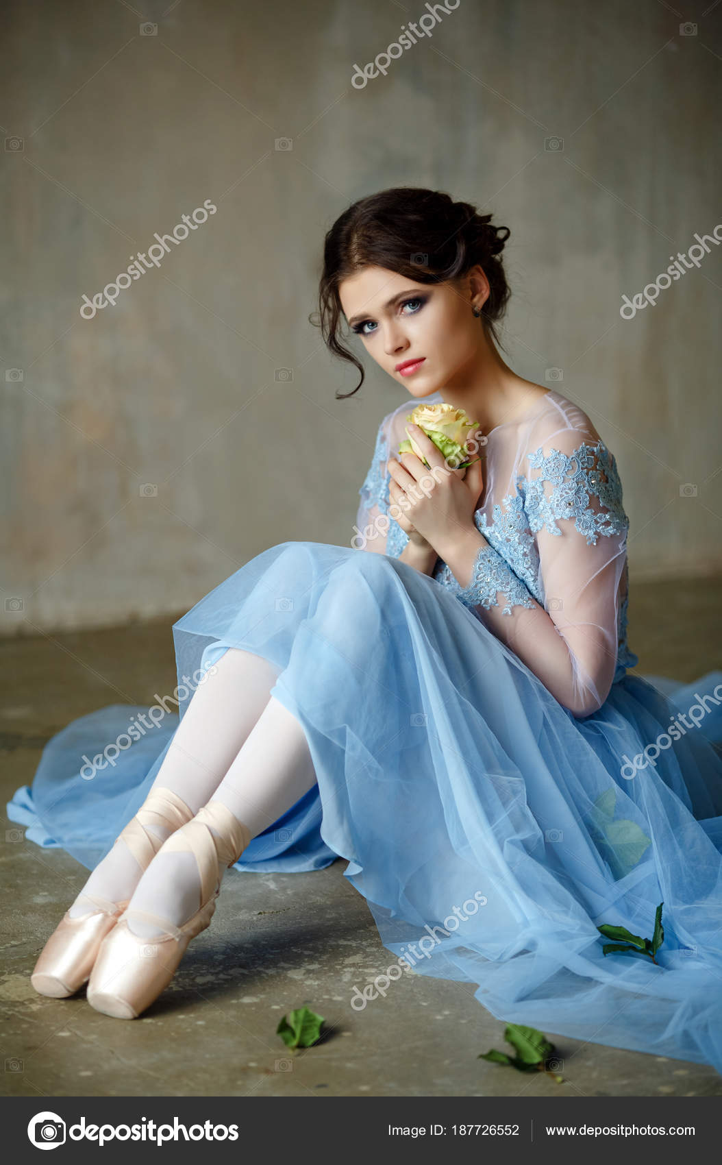 Beautiful graceful girl ballerina in a blue dress and pointe sit Stock ...