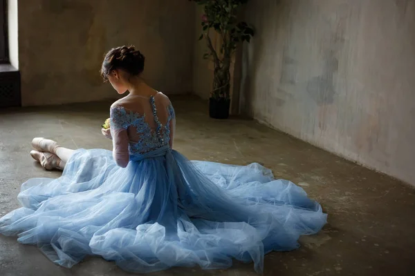 Hermosa elegante chica bailarina en un vestido azul y puntas sentarse — Foto de Stock