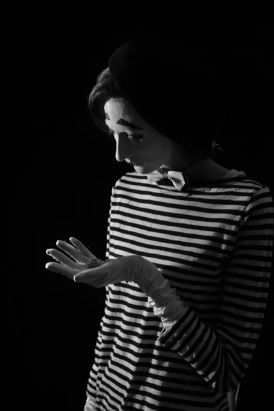 Portrait of sad crying mime on black background. Portrait of a male mime artist standing under umbrella expressing sadness and loneliness. Grunge black background. — Stock Photo, Image