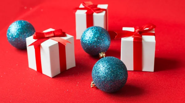 Caixa de presente branco com laço de fita vermelha e bola de Natal — Fotografia de Stock