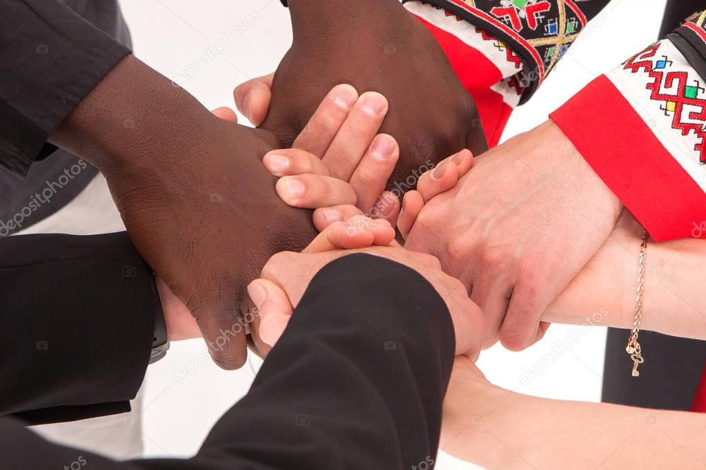 People of different nationalities and religions hold hands. The concept of friendship among peoples.