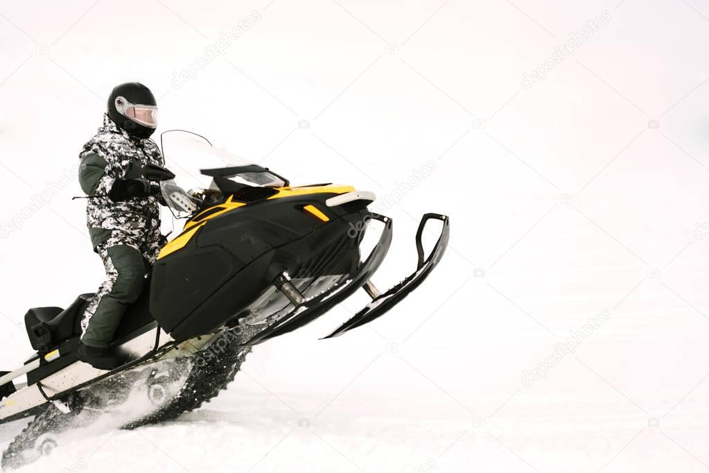 Man on snowmobile. Recreation concept on nature in winter holidays. Winter sports.