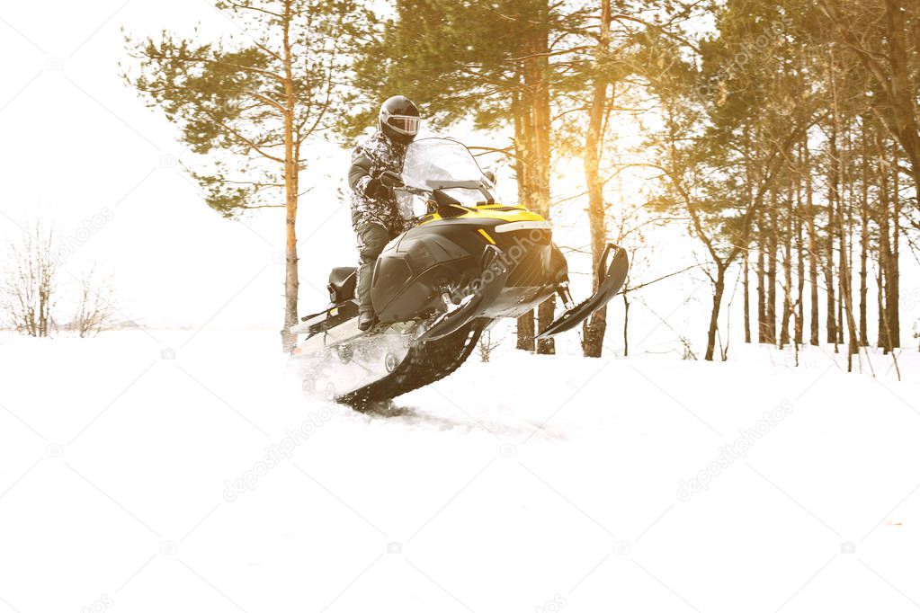 Man on snowmobile. Recreation concept on nature in winter holidays. Winter sports.