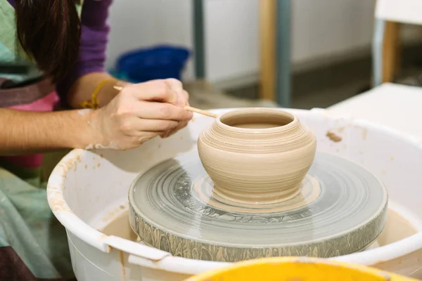 pottery. the teacher teaches the student work on the potter's wheel