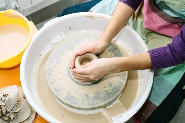 pottery. the teacher teaches the student work on the potter\'s wheel
