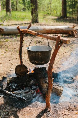 Ateşin yanında kamp. Yemek yemek bir yanıyor. Vahşi kavramı içine yolculuk.