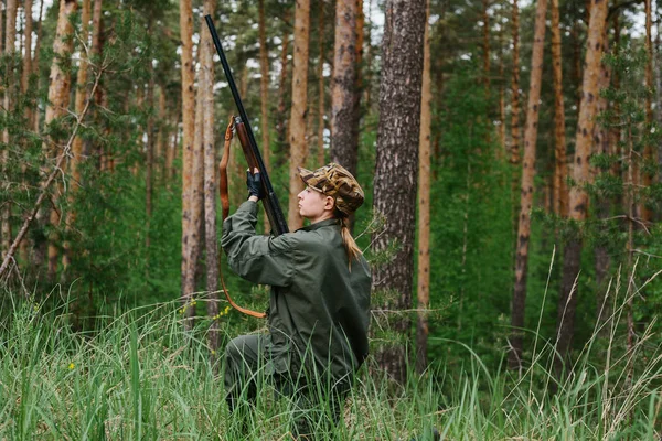 Woman hunter in the woods