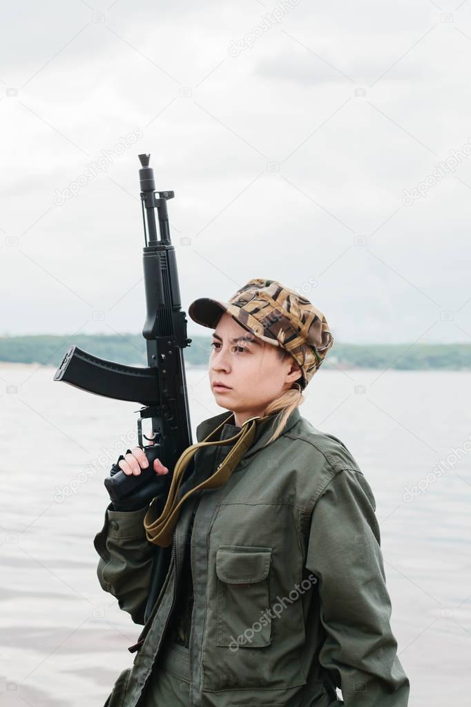 A woman soldier with a weapon