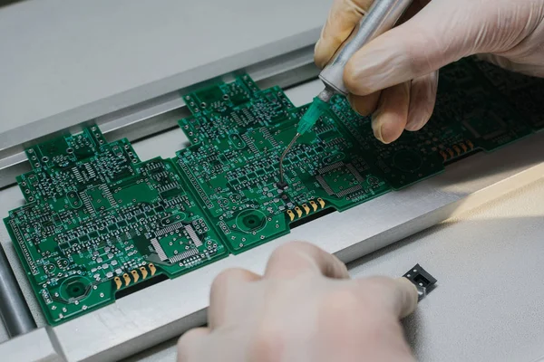 Microchip production factory. Technological process. Assembling the board. Computer expert. Manufacturing. Engineering. Chip. Professional. Technician.