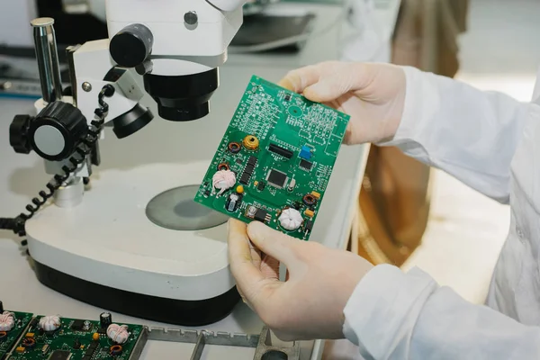 Microchip production factory. Technological process. Assembling the board. Computer expert. Manufacturing. Engineering. Chip. Professional. Technician.