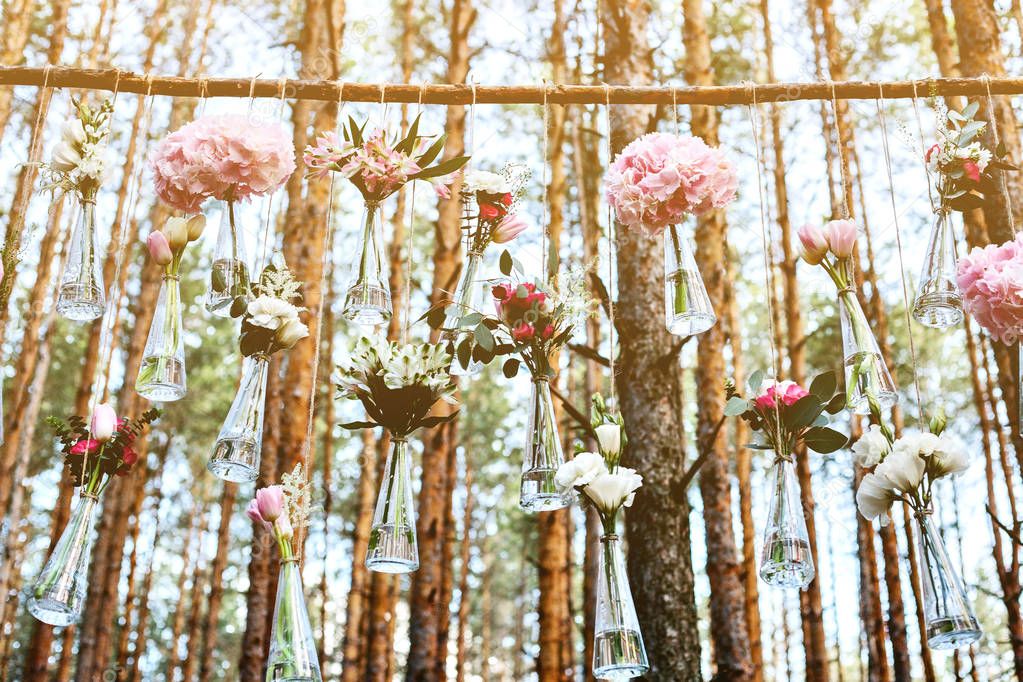 Wedding flowers decoration arch in the forest. The idea of a wedding flower decoration. wedding concept in nature.
